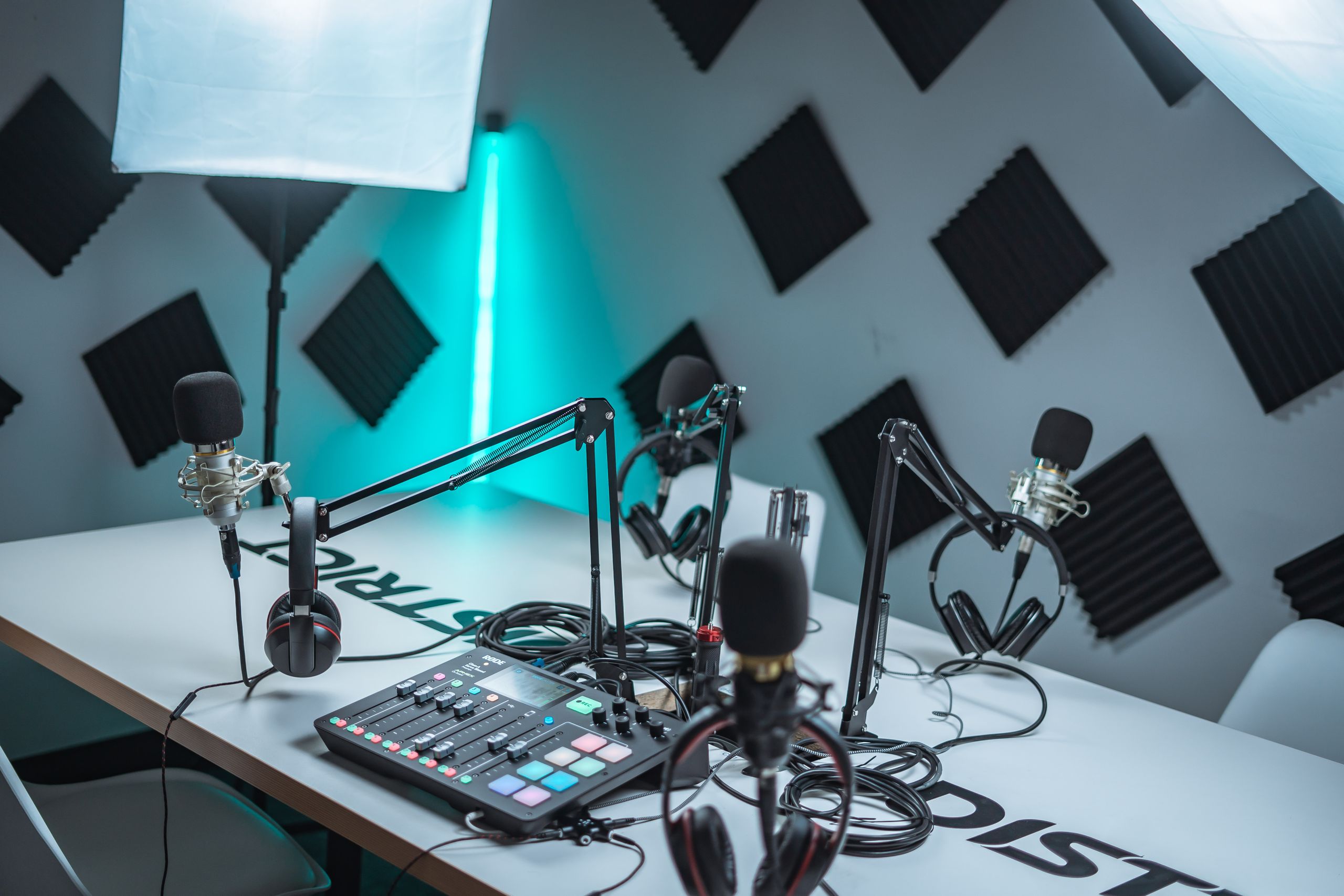 Sleek podcast studio setup featuring microphones, audio mixer, and acoustic panels.